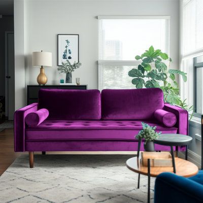 a living room filled with furniture and a pink couch in front of a large window