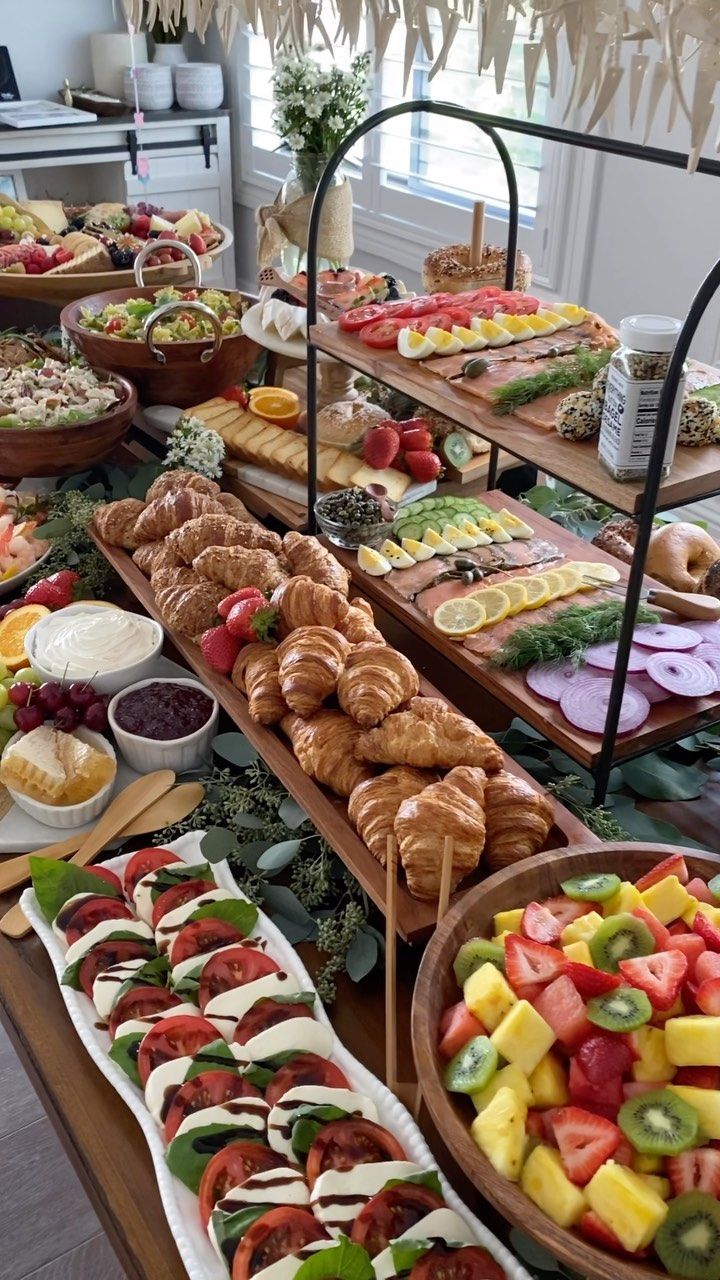 a buffet table filled with lots of different types of food on plates and trays