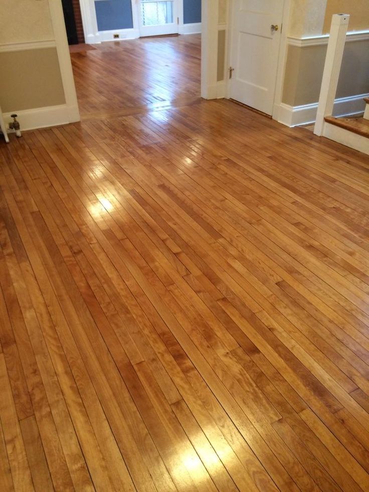 an empty room with hard wood flooring and white trim on the door way to another room