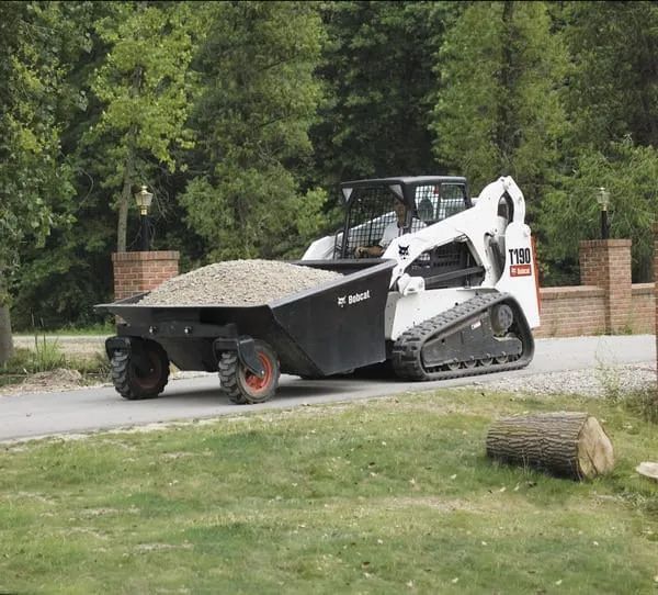 a skid steer is parked on the side of a road