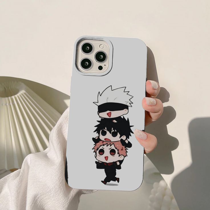 a person holding up a phone case with an anime character on it