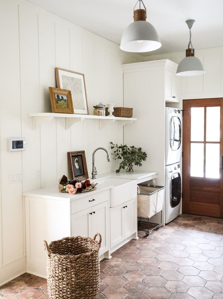 an image of a kitchen with white cabinets and tile flooring on the bottom right hand corner