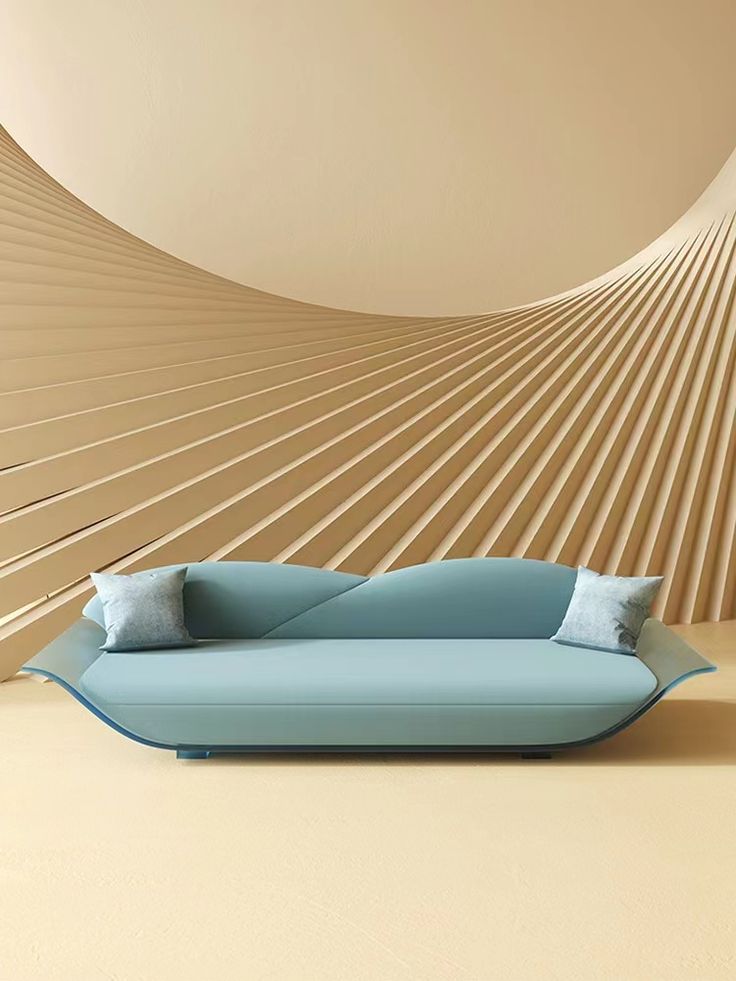 a blue couch sitting in front of a wall with curved lines on it's sides