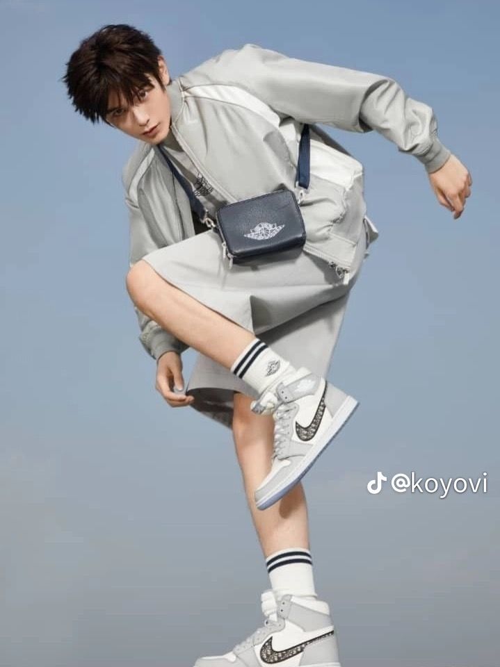 a young man jumping in the air with his foot on top of a skateboard