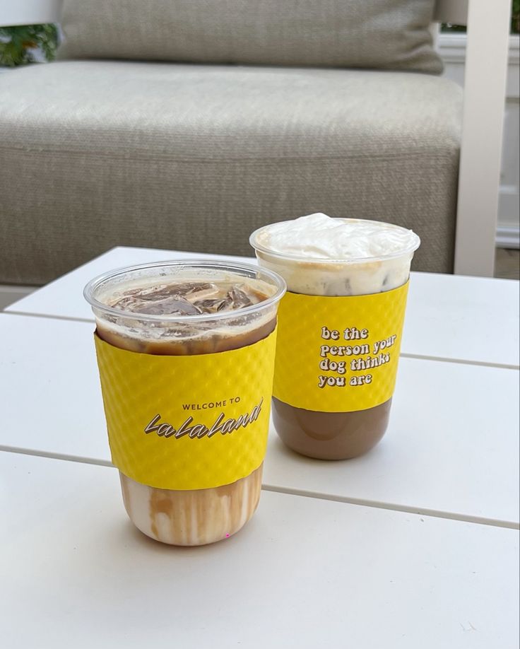 two cups of coffee sitting on top of a table