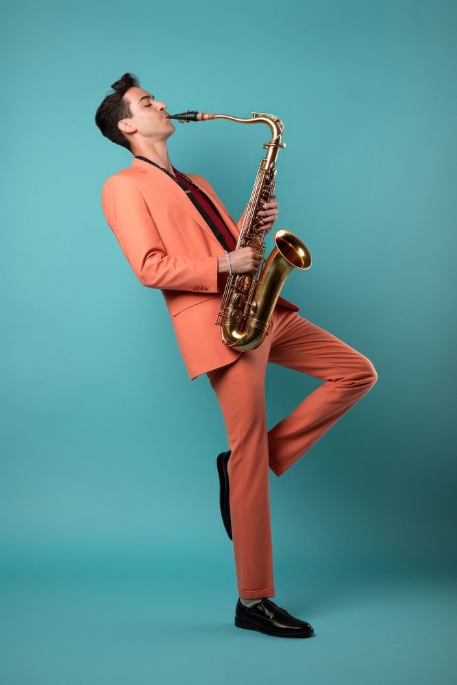 a man in an orange suit is playing the saxophone