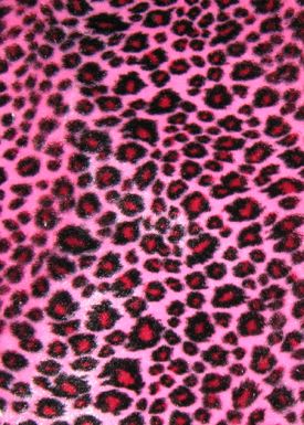 a pink and black animal print fabric with lots of spots on the top of it