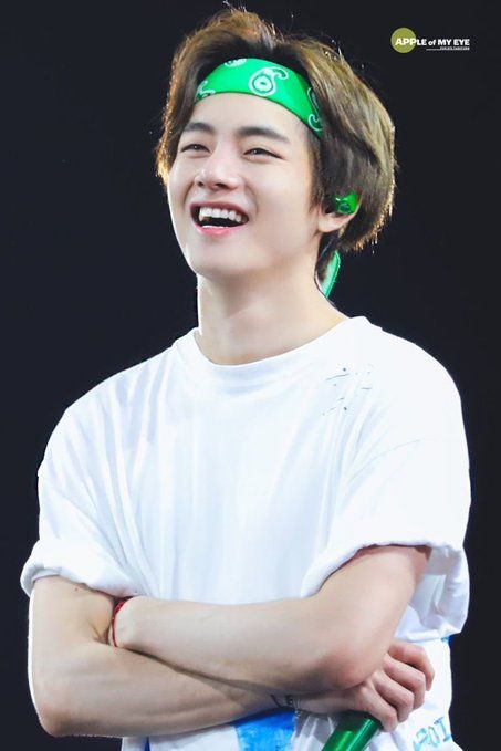 a young man wearing a green headband and smiling