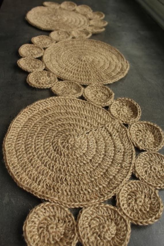 woven placemats are lined up on the floor with circles in each one, along with smaller ones