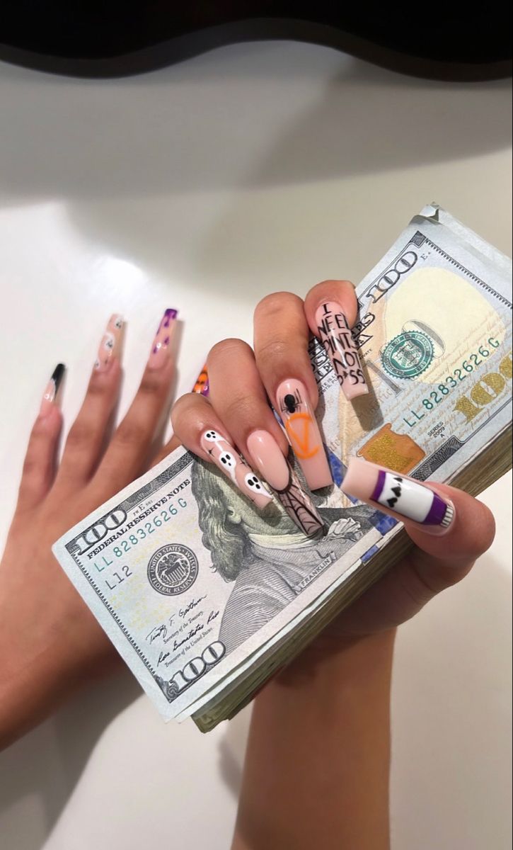 a woman's hands holding money and nails