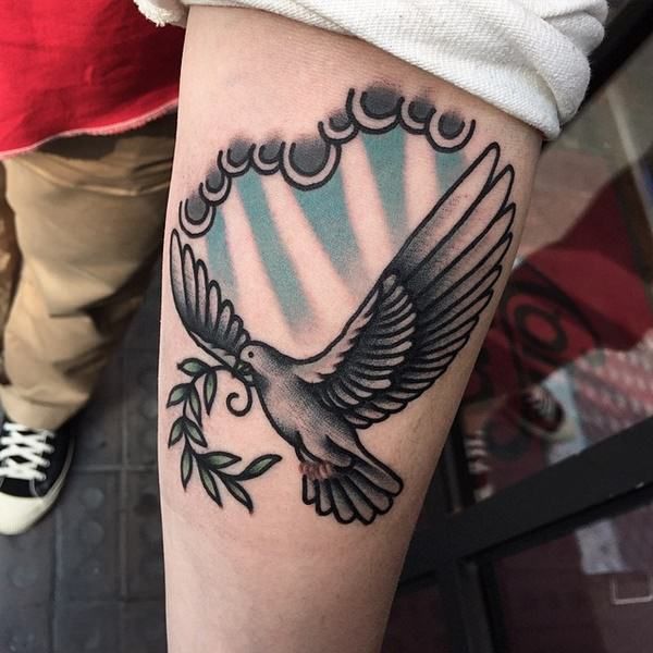 a person with a bird tattoo on their arm