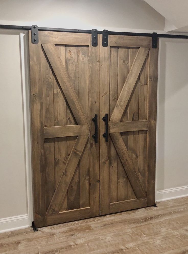 two wooden doors in an empty room