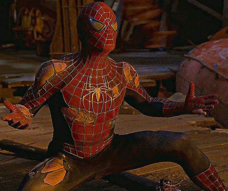 the amazing spider - man is sitting on his knees