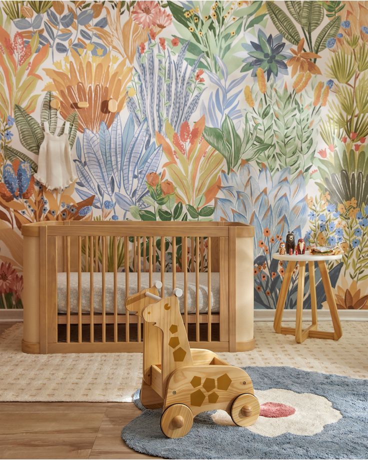 a baby's room with a giraffe toy on the floor