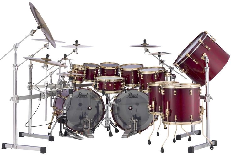 a red drum set sitting on top of a white floor next to a pair of drums