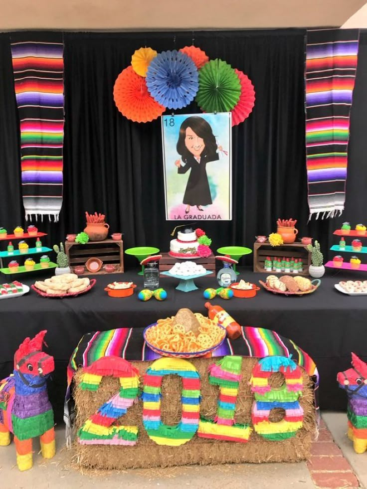 a table topped with lots of colorful desserts and food on top of it's sides