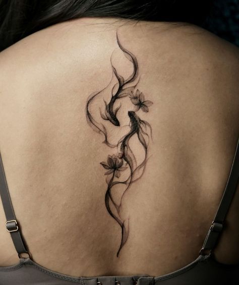 a woman's back with a tattoo on it