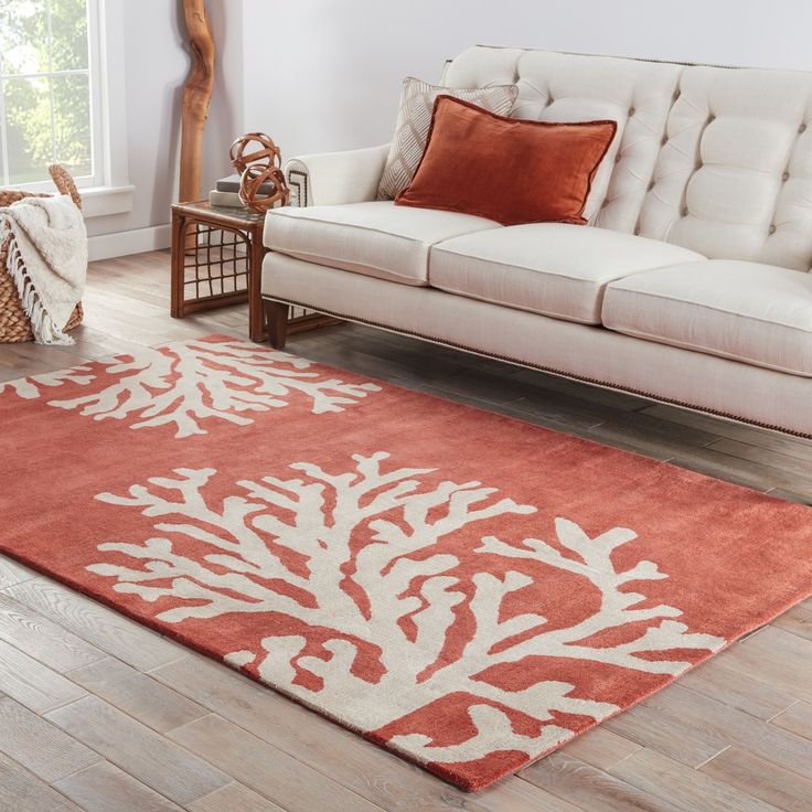 an orange and white rug in a living room