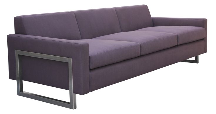 a purple couch sitting on top of a white floor next to a metal frame table