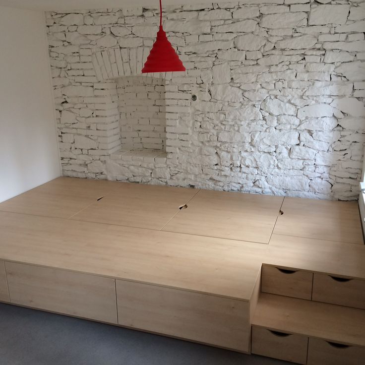 an empty room with some drawers and a red light hanging from the ceiling over it