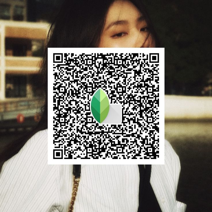 a woman is holding up a qr - code to show the image on her face