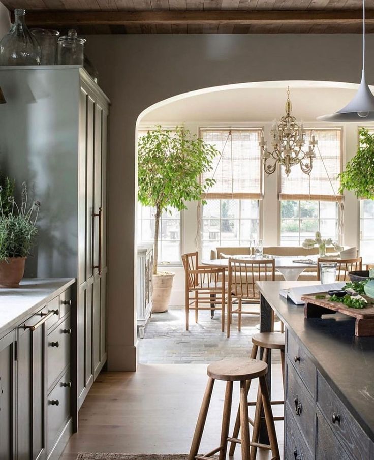 a kitchen with an archway leading into the dining room