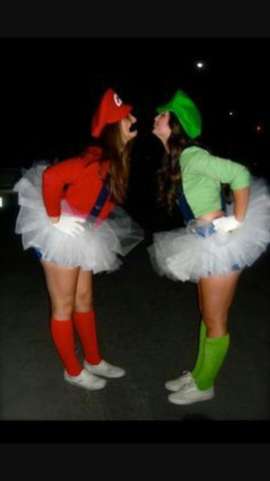 two women dressed in costumes standing next to each other