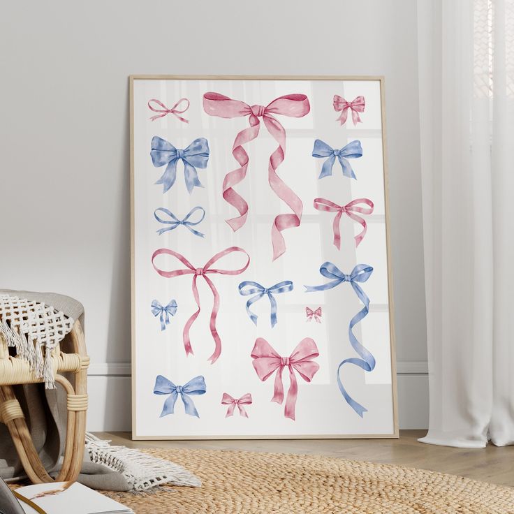 a painting with pink, blue and white bows on it next to a wicker chair