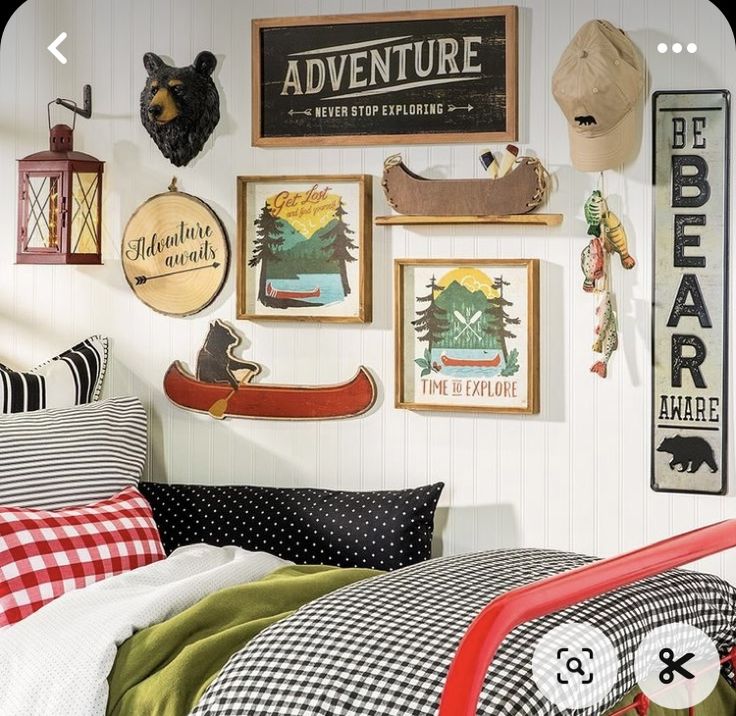 a bed room with a neatly made bed and lots of pictures on the wall