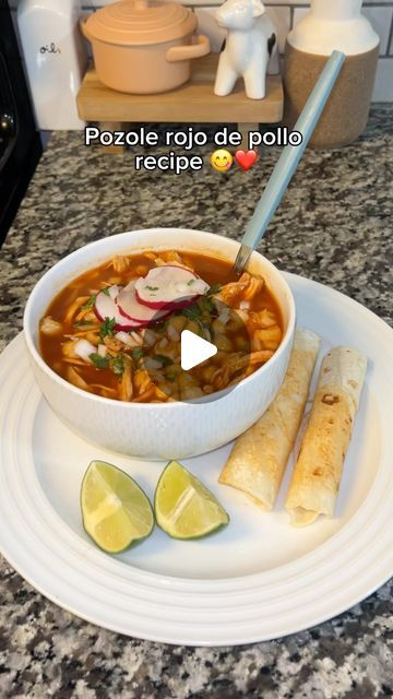 a white plate topped with a bowl of soup and tortilla wrappers on top of it