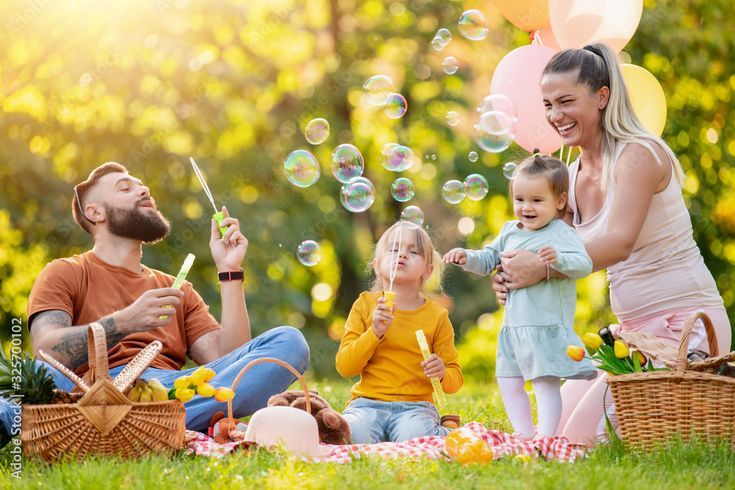 happy family playing with bubbles in the park