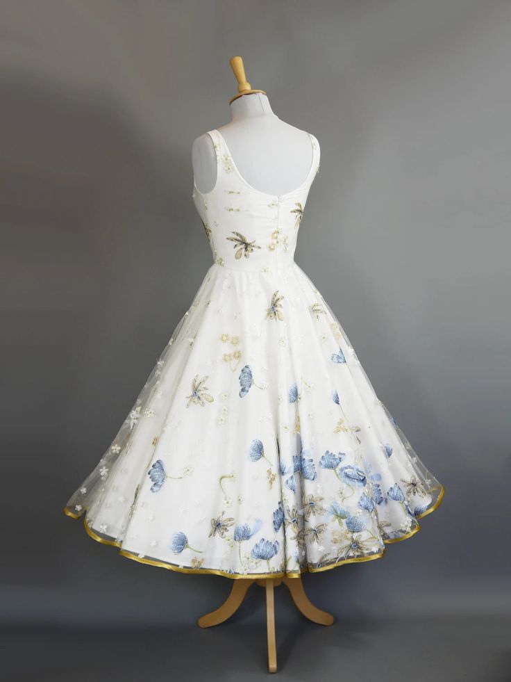 This gorgeous Vintage Style Tea Length Formal Dress is perfect for any special occasion. Crafted of high-quality fabric, it features a retro tea length for a timelessly chic look. Blue poppy embroideries provide an elegant, classic aesthetic for a timelessly stylish look. A stunning choice for an unforgettable night. Bra padding Skirt length approx 28 inches Petticoat required for volume Vintage Wedding Dress 1950s 1940s, 1950s Tea Length Wedding Dress, 1950s Wedding Dress Tea Length, Tea Length Formal Dresses, Dig For Victory, Blue Poppies, Tea Length Wedding, Tea Party Dress, Dream Dresses