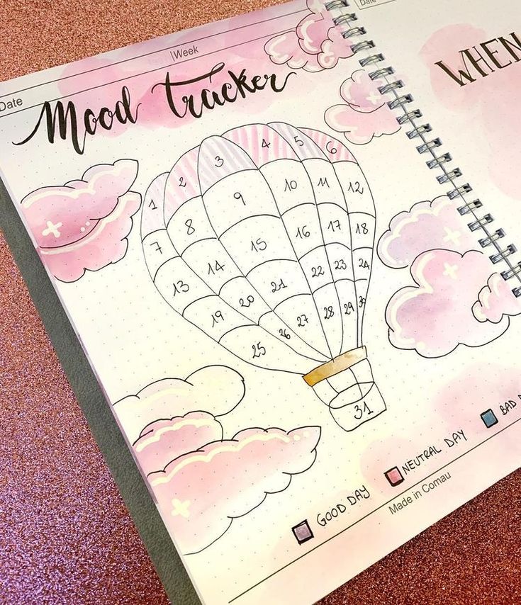 a calendar with a hot air balloon on the cover and pink glitters around it