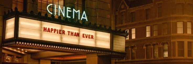 a theater marquee with the words'happy than ever'lit up at night