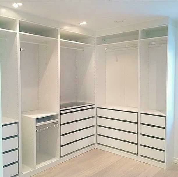 an empty walk in closet with drawers and cabinets