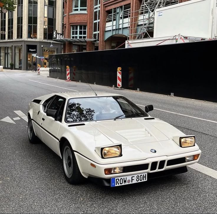 a white car is parked on the street