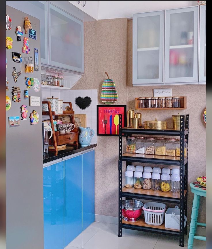 a kitchen with shelves filled with lots of food and toys on the counter top next to a blue cabinet