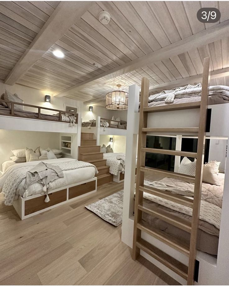 there are bunk beds in this room with stairs to the second floor and another bed on the other side