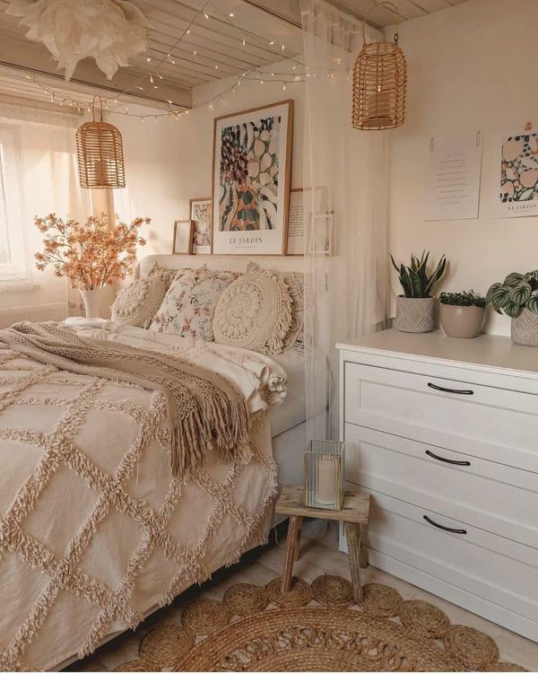 a bed room with a neatly made bed and lots of lights hanging from the ceiling