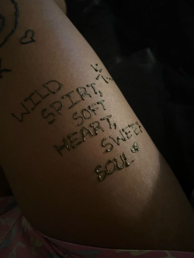 the back of a woman's arm with writing on it