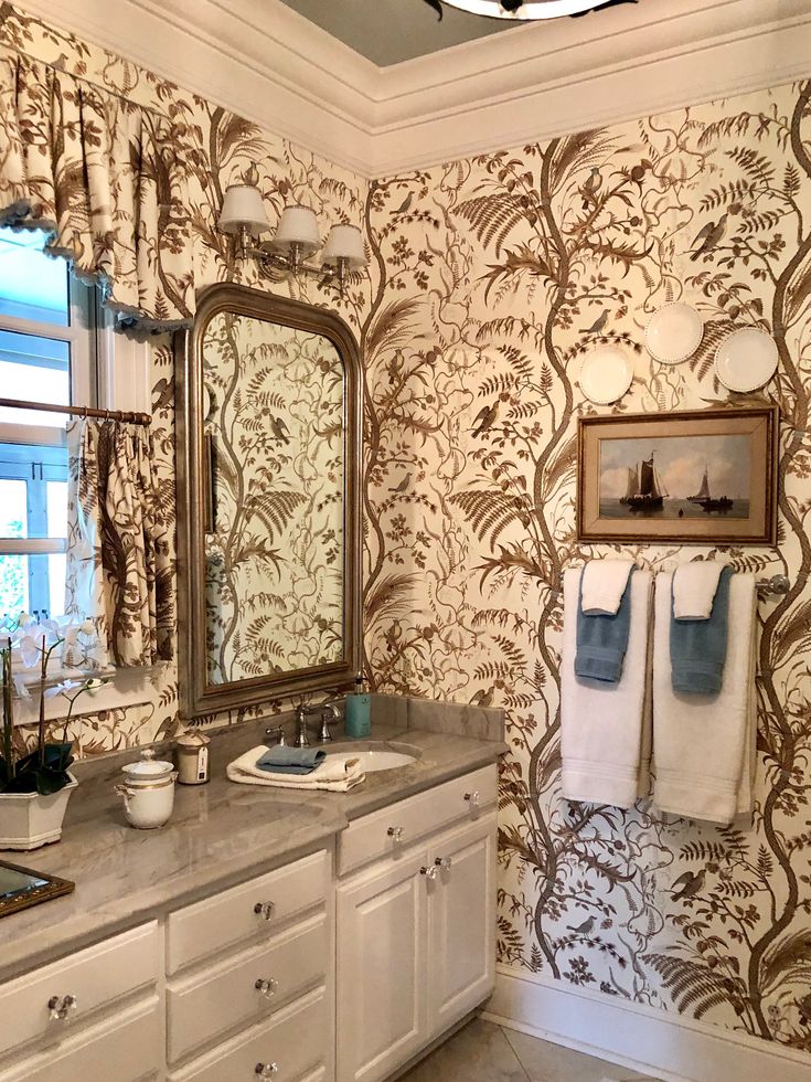 a bathroom with two sinks, mirrors and towels on the rack in front of it