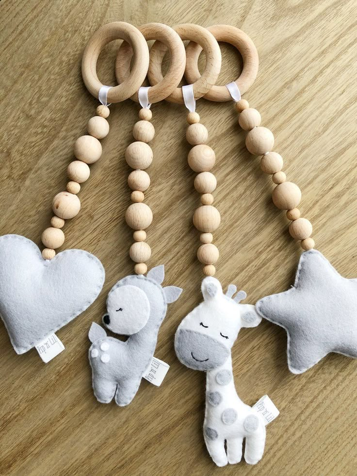 two giraffes and a baby's pacifier on a wooden table