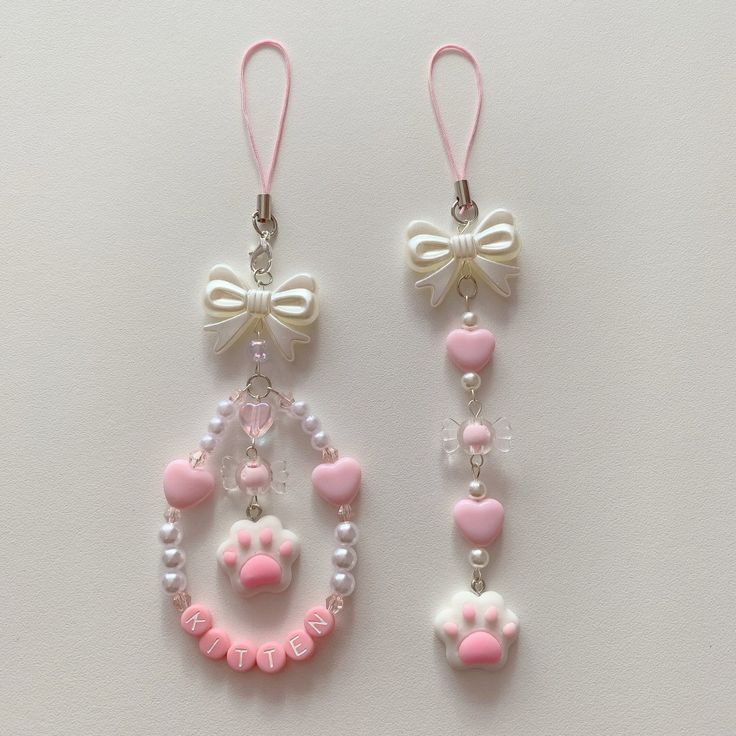 two pairs of pink and white earrings with bowknots hanging from the ends