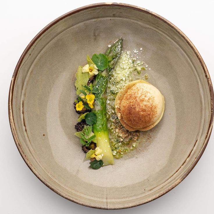 a bowl filled with food on top of a white table