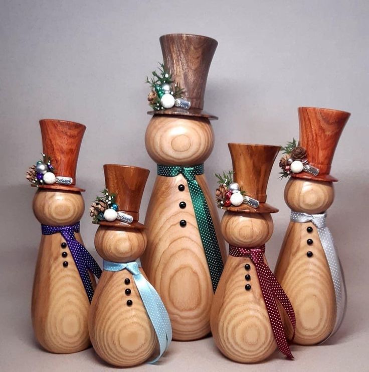 a group of wooden snowmen with hats and ties