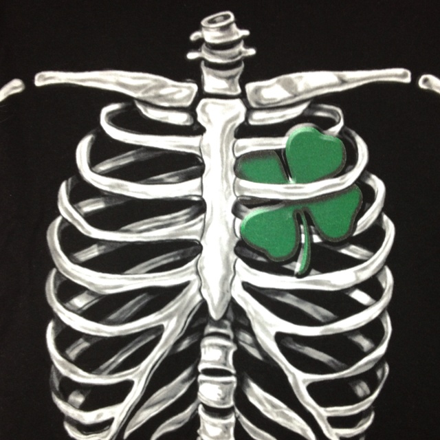 a drawing of a skeleton with four leaf clovers on it's ribcage