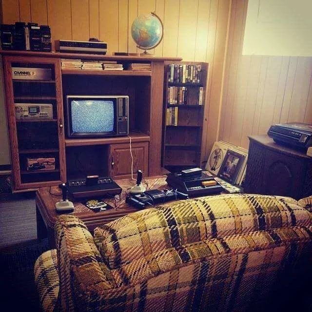 a living room filled with furniture and a tv on top of a wooden entertainment center