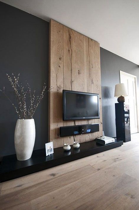 a large flat screen tv mounted to the side of a wall in a living room