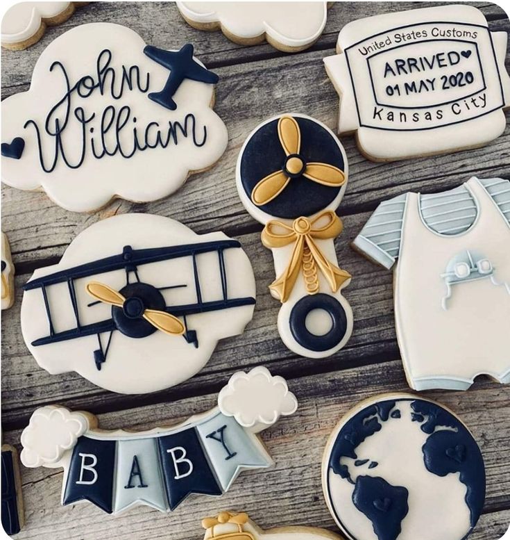 baby shower cookies are arranged on a wooden table