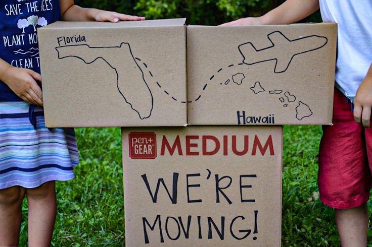 three children holding cardboard signs with the words medium, we're moving on them